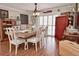 Light-filled dining room boasting hardwood floors, modern furnishings, shuttered doors, and a ceiling fan at 1198 Jamaica Rd, Venice, FL 34293