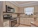 Well-equipped kitchen featuring stainless steel appliances, granite countertops, and ample cabinet space at 1198 Jamaica Rd, Venice, FL 34293