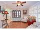 Comfortable and stylish living room featuring hardwood floors, eclectic décor, and plenty of natural light at 1198 Jamaica Rd, Venice, FL 34293