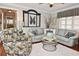 Inviting living room featuring a plush sofa, accent chair, and stylish decor at 1198 Jamaica Rd, Venice, FL 34293