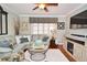 Cozy living room with comfortable seating, hardwood floors, decorative window treatments, and ample natural light at 1198 Jamaica Rd, Venice, FL 34293