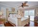 Bright and airy main bedroom with hardwood floors, a ceiling fan, shuttered windows, and stylish furnishings at 1198 Jamaica Rd, Venice, FL 34293