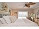Comfortable main bedroom with hardwood floors, a decorative wreath, shuttered windows, and a ceiling fan at 1198 Jamaica Rd, Venice, FL 34293
