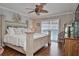 Serene main bedroom with hardwood floors, a ceiling fan, shuttered windows, and stylish furnishings at 1198 Jamaica Rd, Venice, FL 34293
