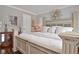 Elegant main bedroom features hardwood floors, a wreath on the headboard, shuttered windows, and natural light at 1198 Jamaica Rd, Venice, FL 34293