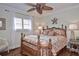 Cozy bedroom with a decorative ceiling fan, shuttered windows and a tropical design style at 1198 Jamaica Rd, Venice, FL 34293