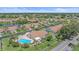 Aerial view of villa featuring a private pool, manicured landscaping, and a peaceful residential neighborhood at 1211 Capri Isles Blvd # 6, Venice, FL 34292