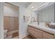 Modern bathroom featuring a dual sink vanity with decorative mirror and separate toilet area at 1211 Capri Isles Blvd # 6, Venice, FL 34292