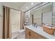 Stylish bathroom featuring patterned wallpaper, modern vanity, and bathtub with shower at 1211 Capri Isles Blvd # 6, Venice, FL 34292
