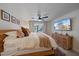 Bright bedroom featuring a large bed, mounted TV, and coordinating wood furniture at 1211 Capri Isles Blvd # 6, Venice, FL 34292