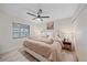 Comfortable bedroom with plush bedding, a ceiling fan, and a cozy atmosphere at 1211 Capri Isles Blvd # 6, Venice, FL 34292