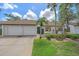 Charming single-story home with a well-manicured front yard, two-car garage, and inviting curb appeal at 1211 Capri Isles Blvd # 6, Venice, FL 34292