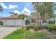 Charming single-story home with a well-manicured front yard, two-car garage, and inviting curb appeal at 1211 Capri Isles Blvd # 6, Venice, FL 34292