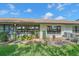 Charming home exterior with well-maintained landscaping and a cozy outdoor space, perfect for relaxation at 1211 Capri Isles Blvd # 6, Venice, FL 34292