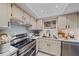 Modern kitchen features stainless steel appliances, bright countertops, and updated lighting at 1211 Capri Isles Blvd # 6, Venice, FL 34292