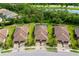Stunning aerial view of multiple homes featuring tile roofs, well-kept lawns, and beautiful landscaping in a tranquil setting at 12187 Amica Loop, Venice, FL 34293