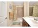 Bathroom showcases a shower-tub combo, vanity with storage, and neutral color scheme at 12187 Amica Loop, Venice, FL 34293