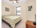 Cozy bedroom featuring natural light, carpeted floors, and tropical art at 12187 Amica Loop, Venice, FL 34293