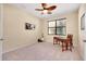 Bright bedroom with a ceiling fan, natural light, and a functional workspace at 12187 Amica Loop, Venice, FL 34293