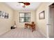 Bedroom features a ceiling fan, natural light, and a practical desk setup at 12187 Amica Loop, Venice, FL 34293