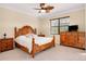 Comfortable bedroom featuring wooden furnishings and large dresser at 12187 Amica Loop, Venice, FL 34293