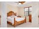 Cozy bedroom with a wood-trimmed bed frame and bright natural light at 12187 Amica Loop, Venice, FL 34293