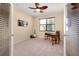 Versatile bedroom features a ceiling fan, natural light, and stylish desk area at 12187 Amica Loop, Venice, FL 34293