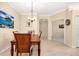 Dining table set for four with tiled floors and neutral walls between the kitchen and an office at 12187 Amica Loop, Venice, FL 34293