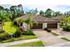 Charming home featuring a brick driveway, beautiful landscaping, and a tiled roof at 12187 Amica Loop, Venice, FL 34293