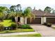 Charming home featuring a brick driveway, beautiful landscaping, and a tiled roof at 12187 Amica Loop, Venice, FL 34293