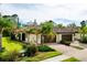 Villa featuring a beautiful tile roof, lush landscaping, and a brick paver driveway at 12187 Amica Loop, Venice, FL 34293