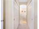 Hallway leading to bathroom featuring dual closets at 12187 Amica Loop, Venice, FL 34293