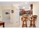 Kitchen bar seating, stainless appliances, and a pass through to the office area with neutral colors at 12187 Amica Loop, Venice, FL 34293