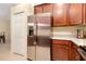 Kitchen features stainless steel refrigerator and granite countertops at 12187 Amica Loop, Venice, FL 34293