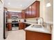 Bright kitchen featuring stainless steel appliances, granite countertops and ample cabinet space at 12187 Amica Loop, Venice, FL 34293