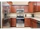Functional kitchen featuring stainless steel appliances and ample cabinet storage space at 12187 Amica Loop, Venice, FL 34293