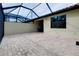 Outdoor screened-in lanai featuring brick flooring with views of the yard and partial coverage at 12187 Amica Loop, Venice, FL 34293