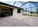 Expansive screened-in lanai featuring brick flooring, blending indoor and outdoor living with a backyard view at 12187 Amica Loop, Venice, FL 34293