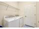 Functional laundry room with washer, dryer, and storage, making chores a breeze at 12187 Amica Loop, Venice, FL 34293