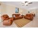 Inviting living room featuring leather furniture, ceiling fan, and neutral color palette at 12187 Amica Loop, Venice, FL 34293