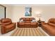 Living room with leather sofa, love seat, accent chair, and decorative pillows at 12187 Amica Loop, Venice, FL 34293
