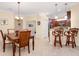 Open floorplan with dining area, kitchen with bar seating, and an office to the left at 12187 Amica Loop, Venice, FL 34293
