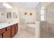 Main bathroom features soaking tub and separate shower at 12187 Amica Loop, Venice, FL 34293