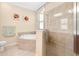 Bathroom features soaking tub and glass enclosed shower at 12187 Amica Loop, Venice, FL 34293