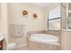Corner soaking tub and glass shower in main bathroom at 12187 Amica Loop, Venice, FL 34293