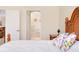 Close up of main bedroom highlighting bedding and view to bathroom at 12187 Amica Loop, Venice, FL 34293