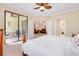 Bright main bedroom features sliding doors to lanai and en-suite bathroom at 12187 Amica Loop, Venice, FL 34293