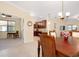 Open floor plan with kitchen bar seating, dining area, and an office to the left at 12187 Amica Loop, Venice, FL 34293