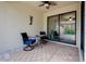 Cozy covered patio with ceiling fan, seating, and sliding glass doors for seamless indoor-outdoor living at 12187 Amica Loop, Venice, FL 34293