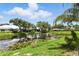 Stunning lake view with beautiful foliage, enhancing the serene backyard of this property at 1234 Harbor Town Way, Venice, FL 34292